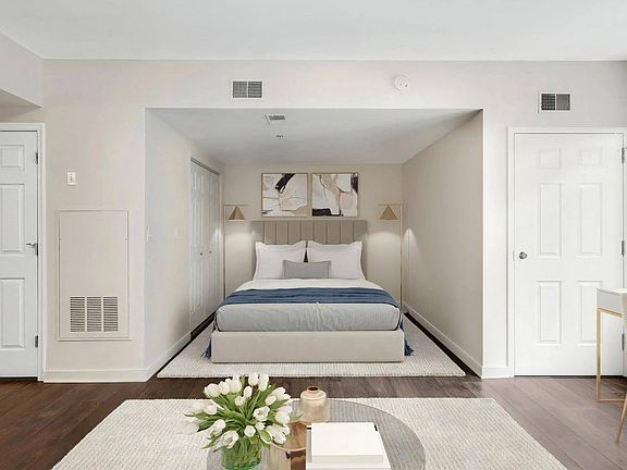 Studio Apartment With Dedicated Sleeping Area and Two Closet Doors