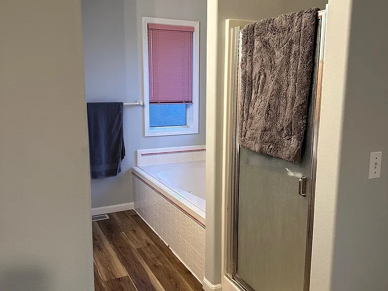 master bathroom, also has toilet and vanity with 2 sinks