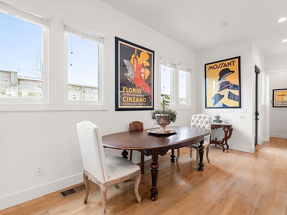 Open living area filled with natural light and seamless flow to kitchen and dining spaces.
