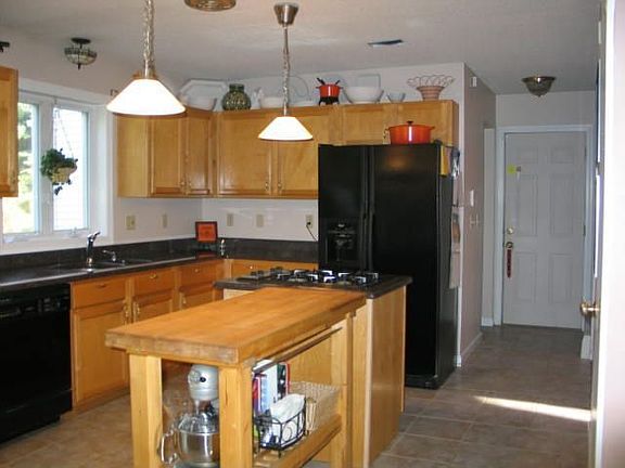 Kitchen opens to living room. Granite counters.