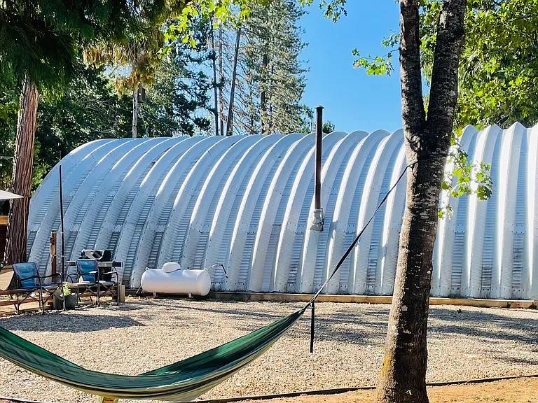 Image of Quonset-Hut-Shop Studio from outside....shows ample space for parking and outdoor fun.