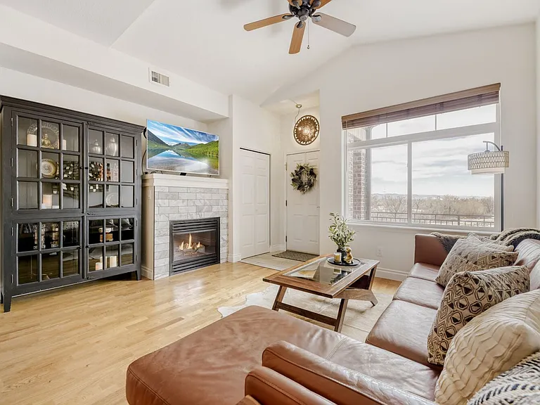 Living room with fantastic mountain and golf course views, gas fireplace