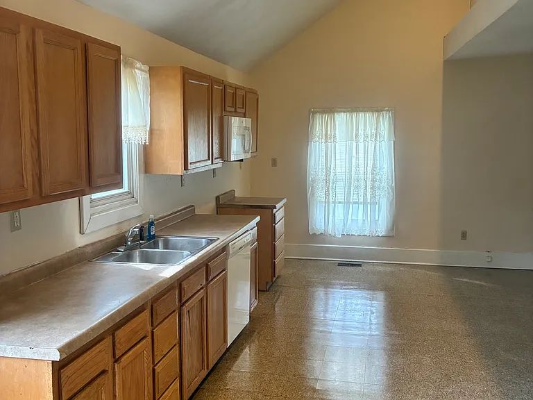 Spacious Kitchen with microwave and dishwasher, vaulted ceiling