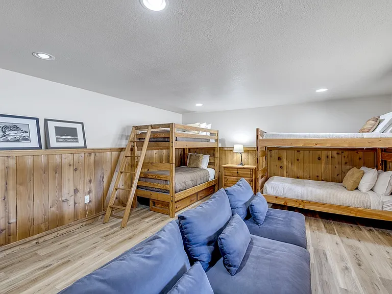 Large kids room with 4 twin beds, 2 sets of bunks. TV and game console.