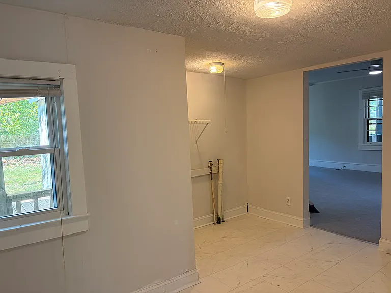 Hallway with washer and dryer hookups.