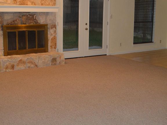 open living / dining with vaulted ceiling and fireplace