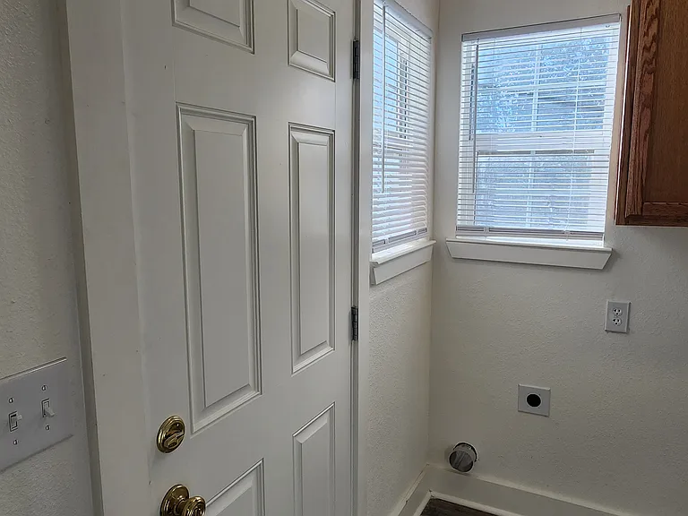 Laundry room with door to backyard