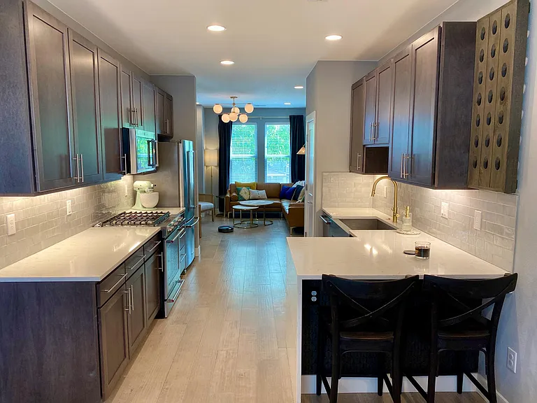 Modern kitchen with tons of cabinet and pantry storage.