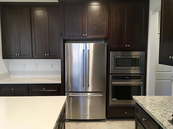 Stainless Steel Kitchen Appliances. Built-in Microwave. In-wall oven. Refrigerator with internal water dispenser and Ice maker.