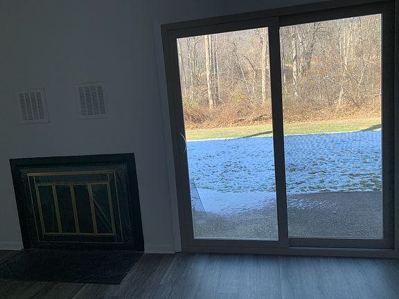 Living room back patio sliding door and wood fireplace