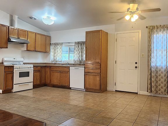 Kitchen: tile floor and high ceiling