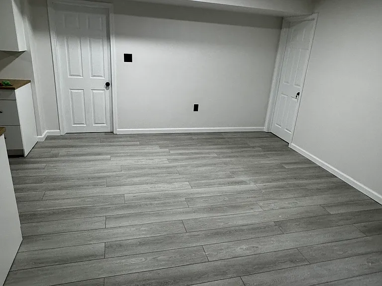Area when you first come into the basement. Another perfect area for a small table, desk, couch and tv.
