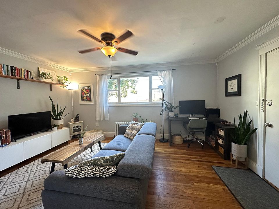 Living room with window above street level and tons of natural light