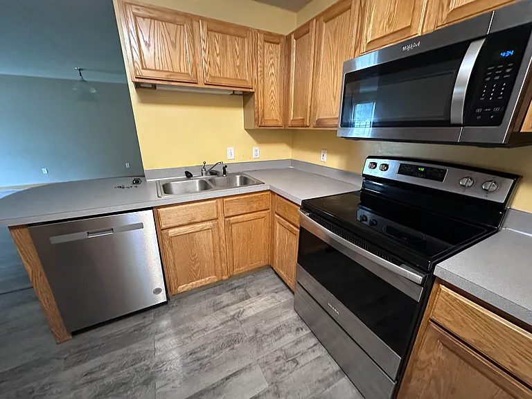 Kitchen with stainless range, microwave, and dishwasher, plus solid oak cabinetry