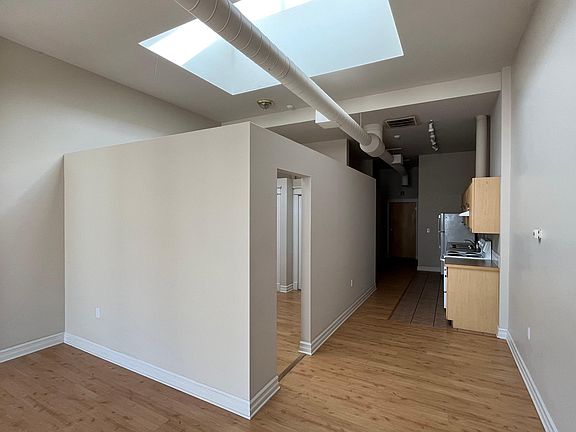 Living room, bedroom, kitchen, and entry.