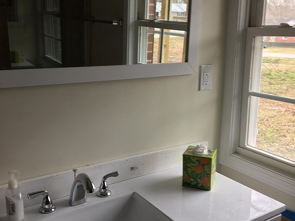 Bathroom with large shower and washer/dryer hookup.