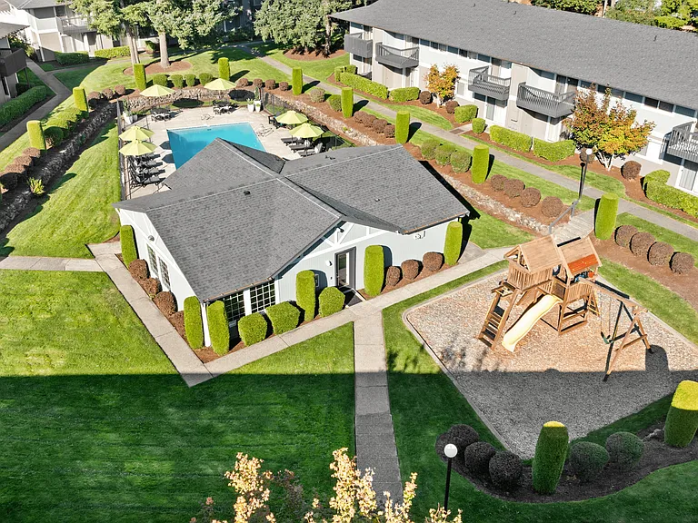 A relaxing community courtyard with pool, playground, and clubhouse.