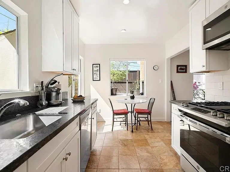 Kitchen with dishwasher, gas stove, microwave and oven.