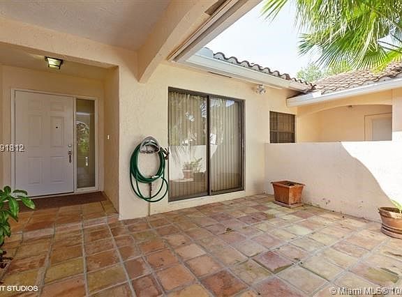 Large front walled patio is great for outdoor dining or private play area