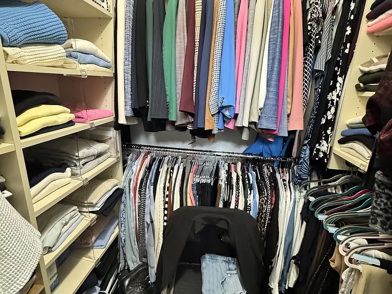 Primary walk in closet with tons of storage.