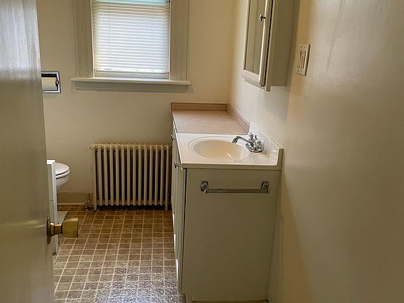 Full bathroom near kitchen, living room and two bedrooms
