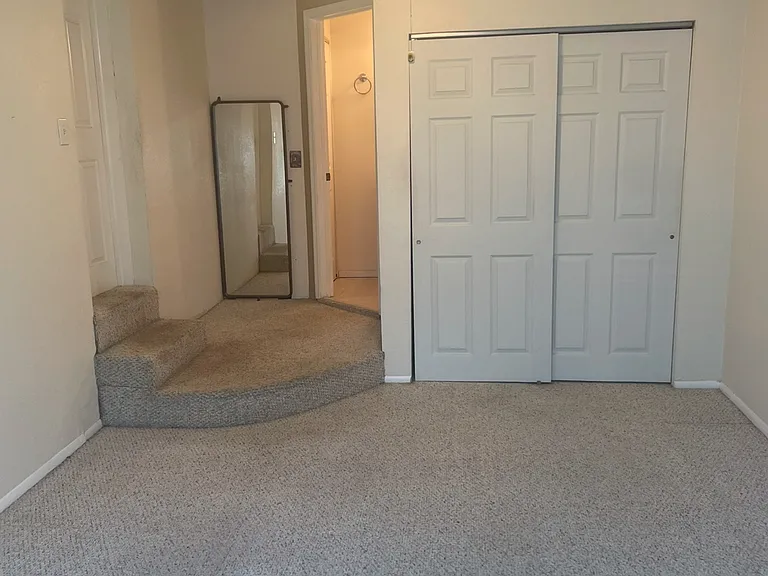 Primary bedroom leading to en-suite bathroom
