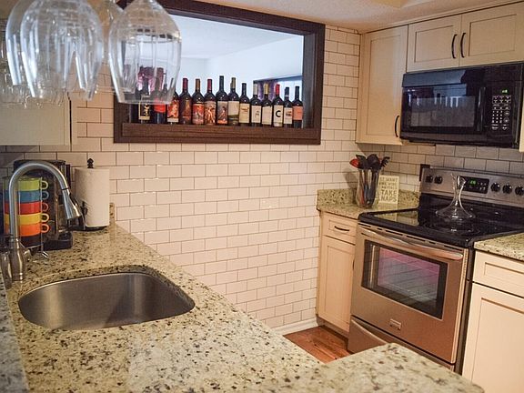 Newly remodeled galley kitchen with stainless steel applianc