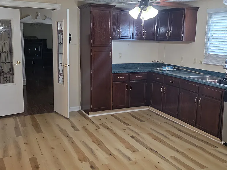 Kitchen going into Dining Room. Cabinets newly varnished, new waterproof flooring