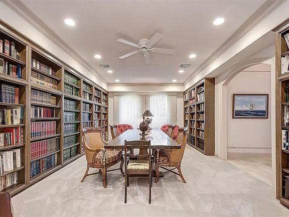 Custom Library with sitting area which  includes  12 built-in book shelves with passage way  pocket door for privacy!