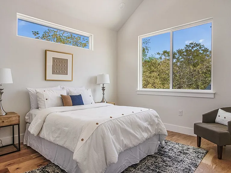 Primary bedroom with vaulted ceilings, ensuite, and walk in, custom closet