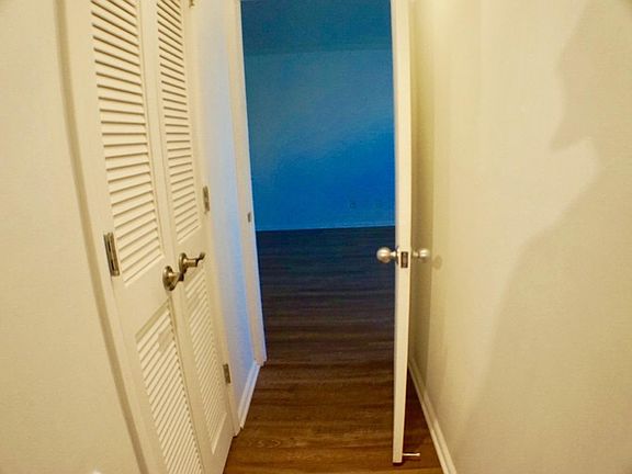Hallway between living room and bedroom contains full bathroom.