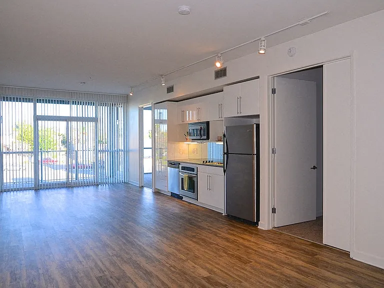 Large living room with open kitchen at 12th Street Lofts in National City, California.