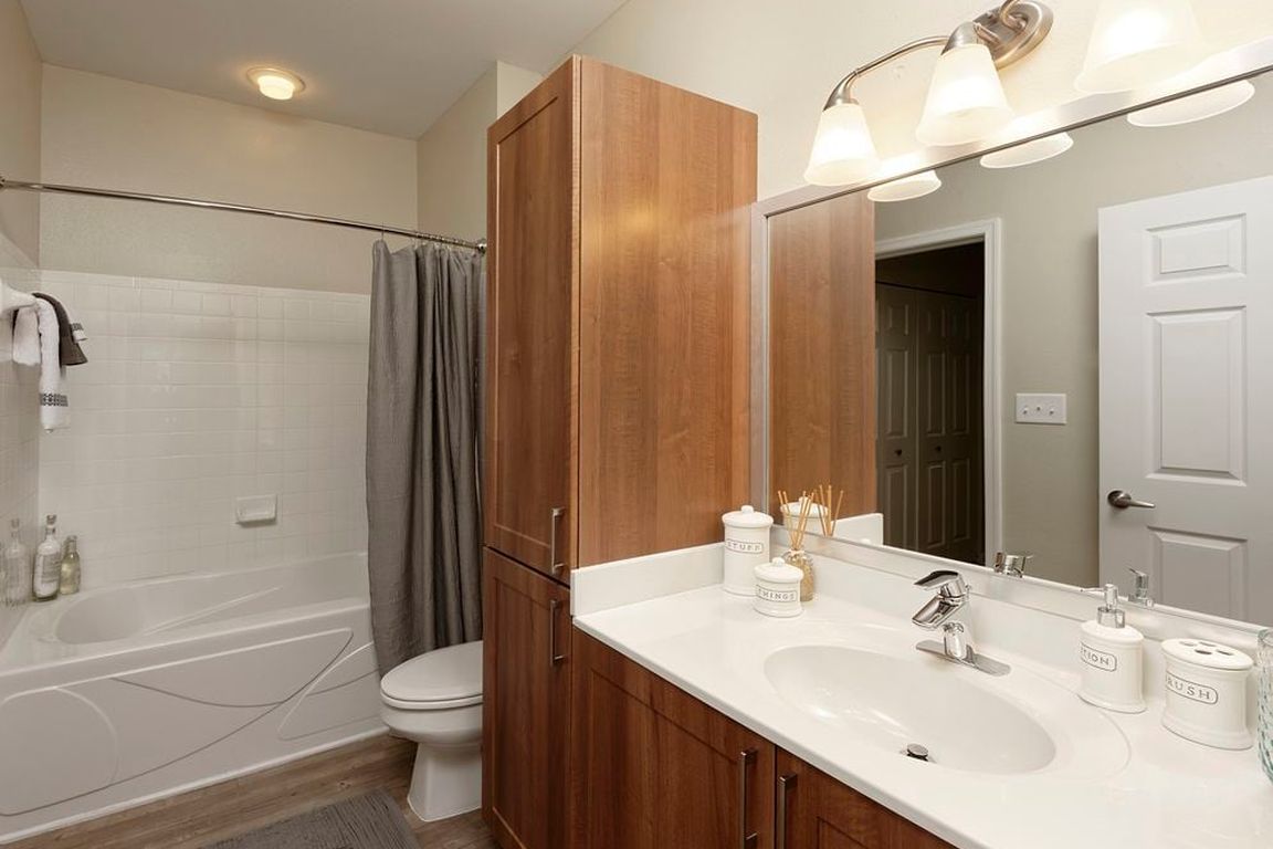 Hazelnut Finish Package bath with white countertop and hard surface flooring