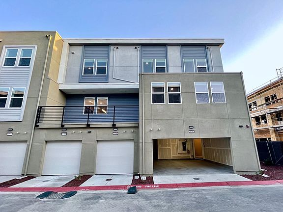 Exterior of the home, with garage door open