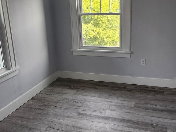 Bedroom - the entire apartment has been renovated with new flooring, windows, and painted