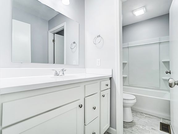 Guest full bathroom including full tub and separate sink area