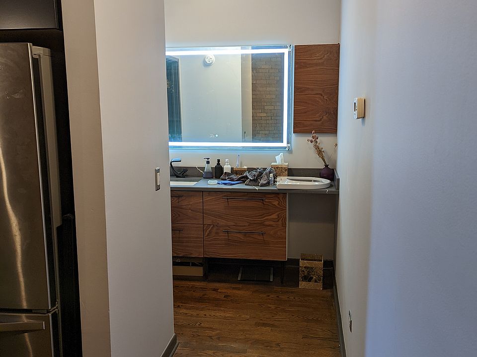 Bathroom mirror has front lighting to easily apply makeup or shave.