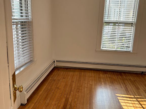 Sunny living room with hardwood floors.