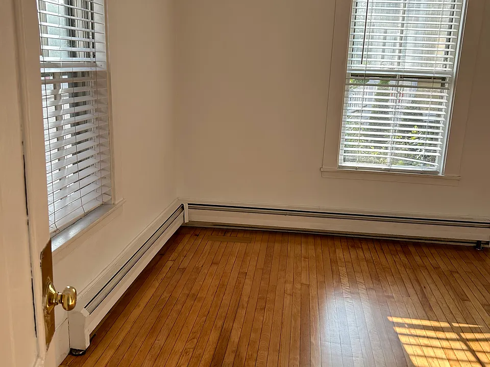 Sunny living room with hardwood floors.