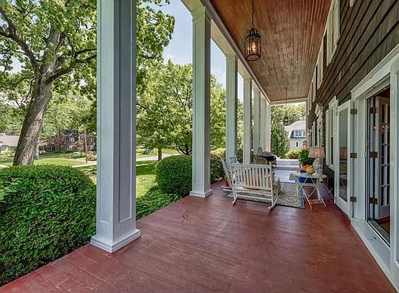 The colonnaded porch is effortlessly accessed from French doors in the living room and dining room.  Both sets of French doors feature retractable screen doors