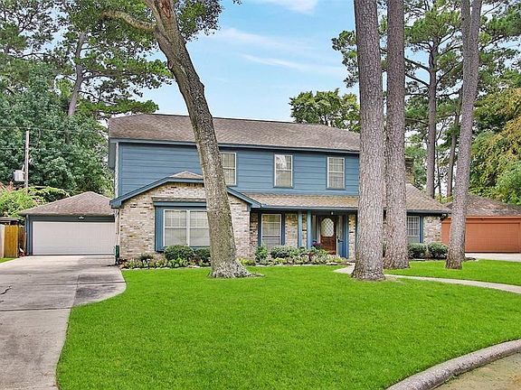 Cul-de-sac lot provides space for long drive way leading to the 2-car garage. Garage door opener replaced 2021.