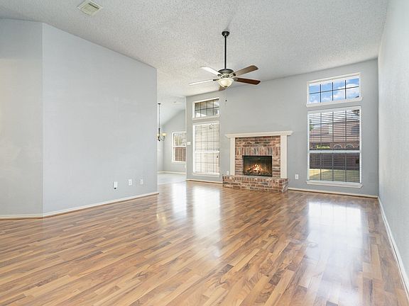 Open living with brick fireplace