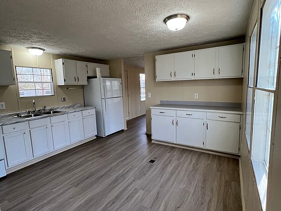 Area for breakfast table and a backyard window view within kitchen.