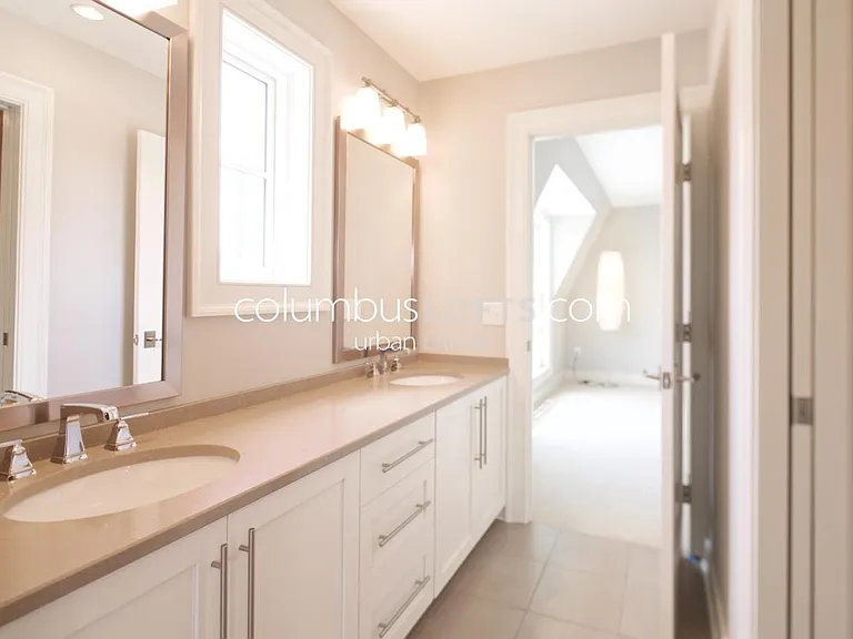 Jack-and-Jill full bathroom in between the 2 upstairs bedrooms connects the 2 bedrooms to one another in between them, features dual vanity sink and separate room with large walk-in shower and toilet (to right in this pic) which pocket door for privacy.
