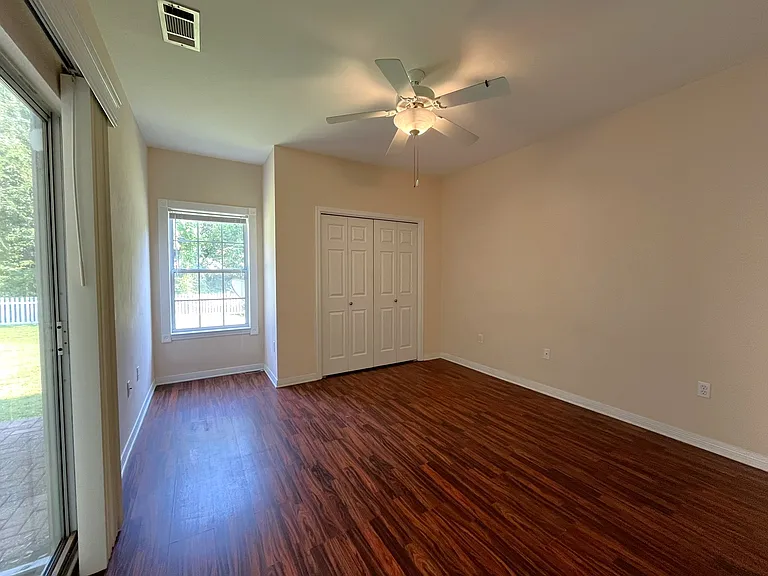 This is a picture of the Master Bedroom. The flooring is a wood looking laminate. This is a downstairs bedroom.