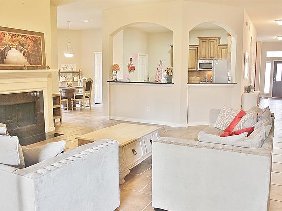 The open floor plan has a great flow! The beautiful tile floor runs from the solid wood front door through the entry way into the kitchen, breakfast and living room.
