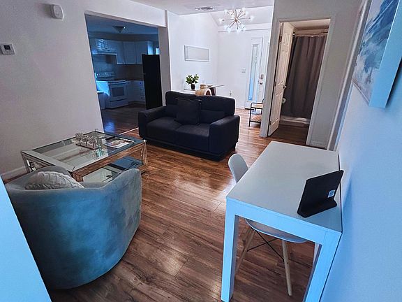 Beautiful living room with loveseat, accent chair, desk, and coffee table.