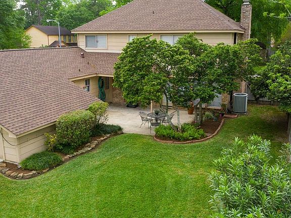 Photo showcases the bump-out at the back of the garage for additional storage, as well as updated roof. Large patio for summer BBQs, lush landscaping and plenty of space for kiddos and fur babies to play.