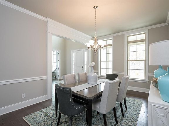 Dining room features large windows and plenty of space for guests