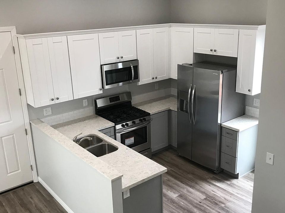 Kitchen area. Quartz counters. Stainless steel appliances, including microwave & dishwasher. Recessed lights. Luxury vinyl flooring.